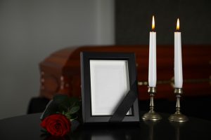 Black,Photo,Frame,With,Burning,Candles,And,Red,Rose,On
