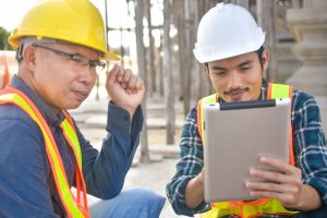 Two,Engineer,Worker,Use,Tablet,On,Site,Construction,Real,Estate